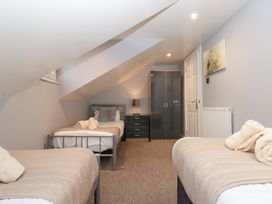 A bedroom with two beds and storage furniture at Seacrest Lodge in Scarborough