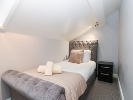 A bedroom with a bed and bedside table at Seacrest Lodge in Scarborough