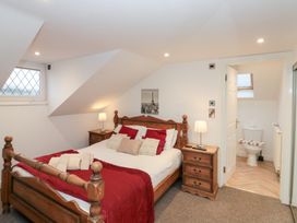 A bedroom with a bed and nightstand at Seacrest Lodge in Scarborough