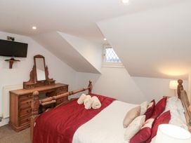 A bedroom with a bed and dresser at Seacrest Lodge in Scarborough