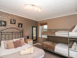 A bedroom with a double bed and a bunk bed at Seacrest Lodge in Scarborough
