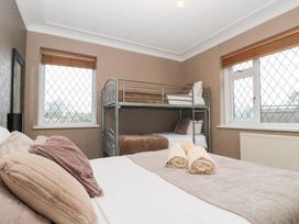 A bedroom with a bunk bed and double bed at Seacrest Lodge in Scarborough