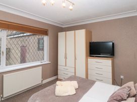 A bedroom with a bed and a wardrobe at Seacrest Lodge, Scarborough