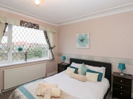 A bedroom with a bed and nightstands at Seacrest Lodge in Scarborough