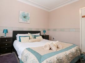 A bedroom with a bed and bedside tables at Seacrest Lodge in Scarborough