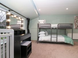 A bedroom with a bunk bed and vanity table at Seacrest Lodge, Scarborough