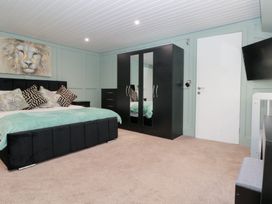 A bedroom with a bed and wardrobe at Seacrest Lodge in Scarborough