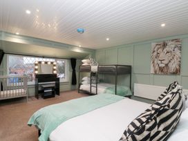 A bedroom with beds and a mirror at Seacrest Lodge in Scarborough