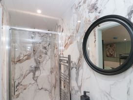 A bathroom with a shower and a towel radiator at Seacrest Lodge in Scarborough