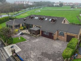 An exterior view of a house with a driveway and garden at Seacrest Lodge in Scarborough