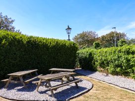 A garden with benches and a lamp post at Seacrest Lodge in Scarborough