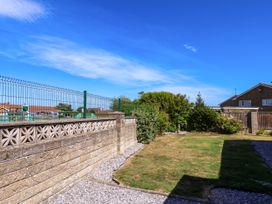 A garden with a wall and fence at Seacrest Lodge in Scarborough