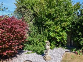 A garden with a statue and bushes at Seacrest Lodge Scarborough
