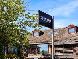 A sign for Sykes Holiday Cottages outside a building in Scarborough
