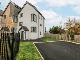 A house with a driveway and fence at Estuary View in Colwyn Bay