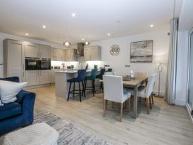 A kitchen with a dining area and seating at Estuary View in Colwyn Bay