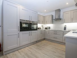 A kitchen with cabinets and appliances at Estuary View in Colwyn Bay