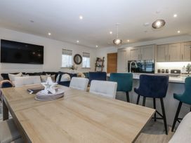 A dining room with a table and chairs at Estuary View in Colwyn Bay