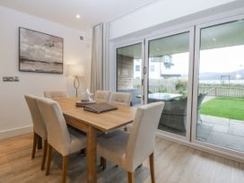 A dining room with a table and chairs at Estuary View in Colwyn Bay
