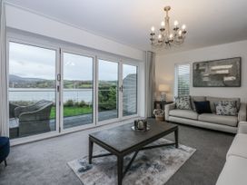 A living room with a sofa and coffee table at Estuary View in Colwyn Bay