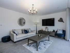 A living room with a sofa and television at Estuary View in Colwyn Bay