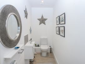 A bathroom with a toilet and sink at Estuary View in Colwyn Bay