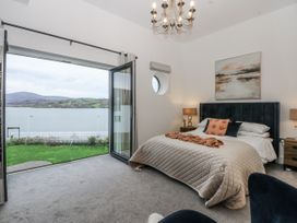 A bedroom with a bed and nightstands at Estuary View in Colwyn Bay