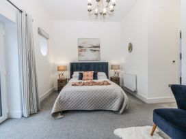 A bedroom with a bed and nightstand at Estuary View in Colwyn Bay