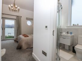 A bedroom with an ensuite bathroom at Estuary View in Colwyn Bay