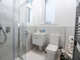 A bathroom with shower and sink at Estuary View in Colwyn Bay