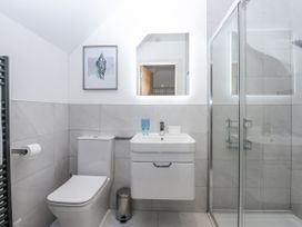 A bathroom with a shower and sink at Estuary View Colwyn Bay