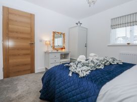 A bedroom with bed and wardrobe at Estuary View in Colwyn Bay