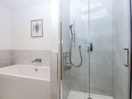 A bathroom with a bathtub and shower at Estuary View in Colwyn Bay