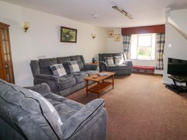 A living room with sofas and a coffee table at Curradoon House in Touraneena, County Waterford