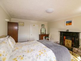 A bedroom with a bed and furniture at Curradoon House, Touraneena, County Waterford