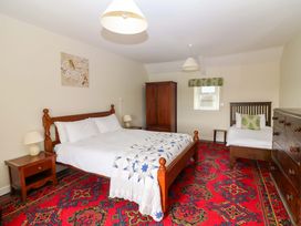 A bedroom with a double bed and single bed at Curradoon House in Touraneena, County Waterford