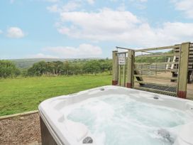 An outdoor hot tub with a view of the landscape at The Cabin in Pontardawe
