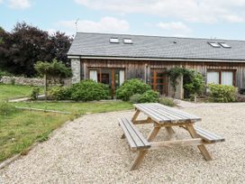 An outdoor table and bench near a house at Budmouth in Upwey near Weymouth