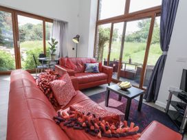 A living room with red sofa and coffee table at Budmouth in Upwey near Weymouth