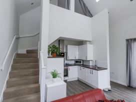 A kitchen with a staircase and seating area at Budmouth in Upwey near Weymouth