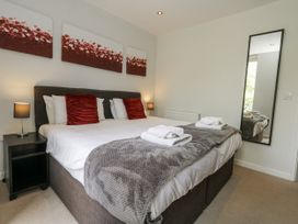 A bedroom with a bed and bedside table at Budmouth in Upwey near Weymouth
