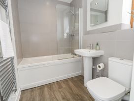 A bathroom with a bathtub, shower, sink, and toilet at Budmouth in Upwey near Weymouth