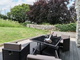 An outdoor patio with a table and chairs at Budmouth in Upwey near Weymouth