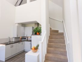 A kitchen with a staircase at Shepherd Oak in Upwey near Weymouth