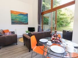 A living room with a dining table and cupcakes at Shepherd Oak in Upwey near Weymouth