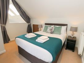 A bedroom with a bed and window at Shepherd Oak Upwey near Weymouth