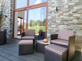An outdoor seating area with chairs and a table at Shepherd Oak in Upwey near Weymouth
