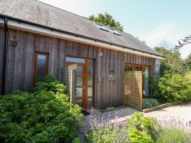 An exterior view of a house with plants in the garden at Shepherd Oak near Weymouth