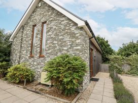 Exterior view of a house with stone wall and bushes at Everdene Upwey near Weymouth