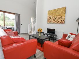 A living room with a sofa and television at Everdene Upwey near Weymouth